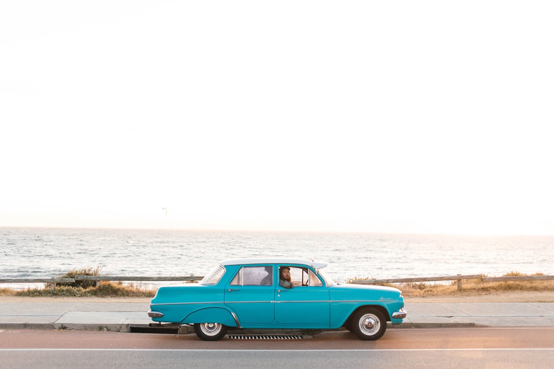 Vintage car traveling along the beach